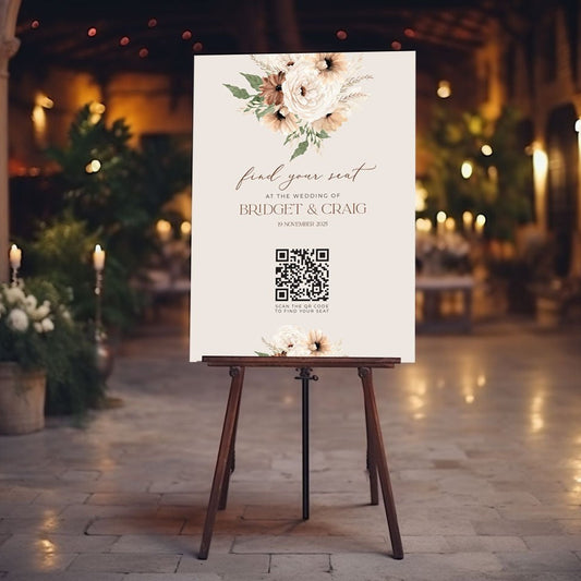 qr code table seating sign sitting on easel at wedding reception featuring boho peonie floral bouquet