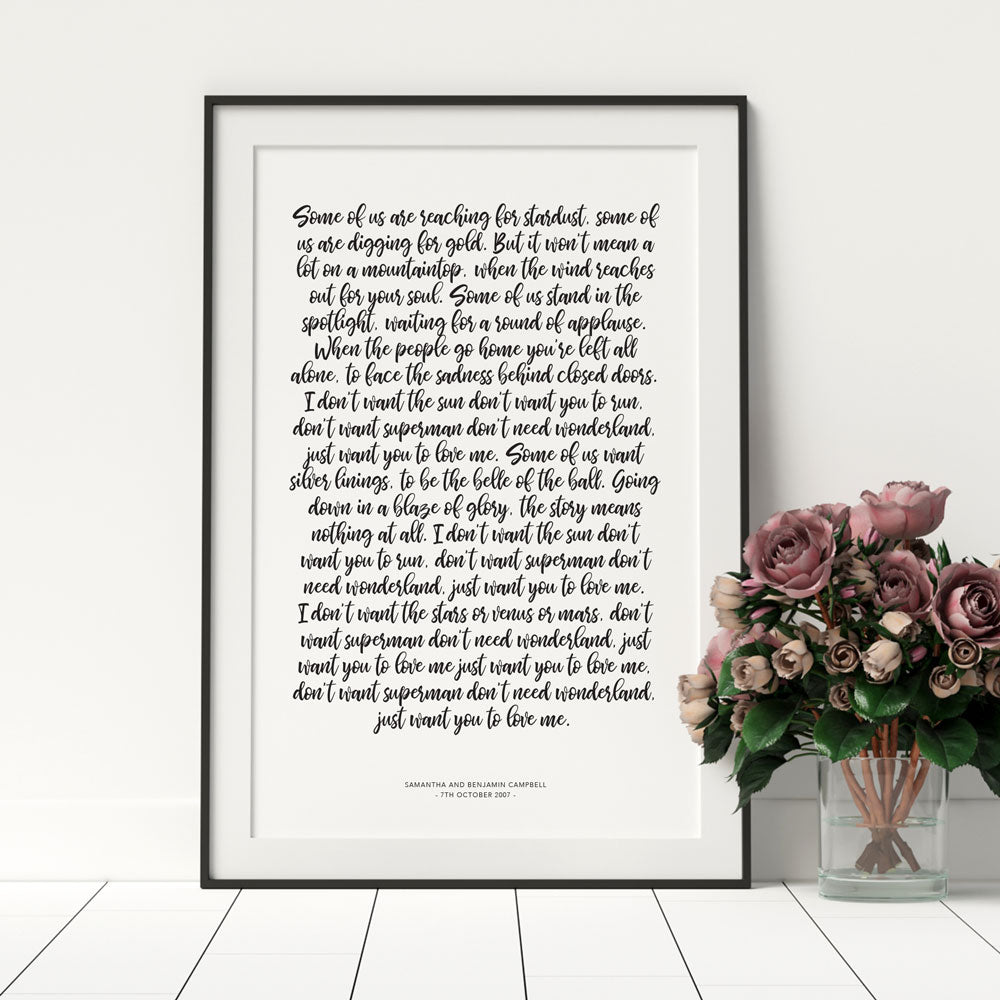 1st year wedding anniversary vow prints in a handwritten script font in a black frame with florals in a vase