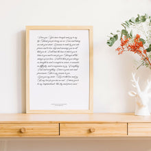 1st year wedding anniversary vow prints in a script font in frame on timber table 