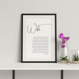 1st year wedding anniversary vow print for wife in a black frame with flowers in vase