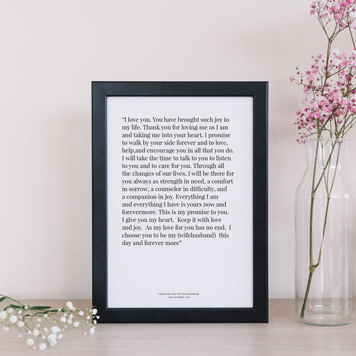1st year wedding anniversary vow print in black frame with flowers in vase