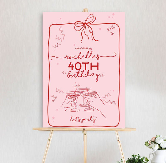 amore themed welcome sign in pink red with champagne glass, hearts and streamers