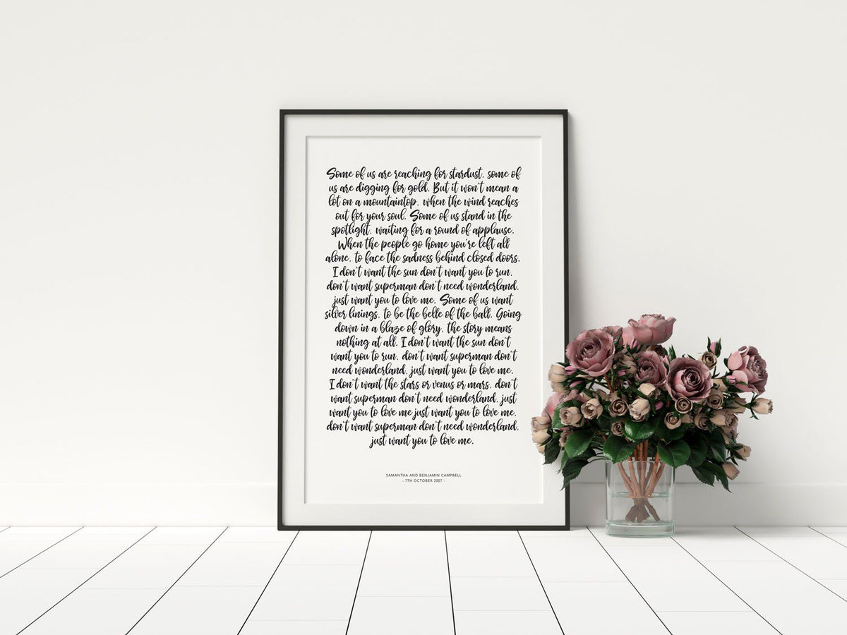 1st year wedding anniversary vow prints in a handwritten script font in a black frame with florals in a vase