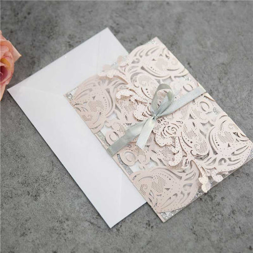 blush pink laser cut invitation with silver glitter closed