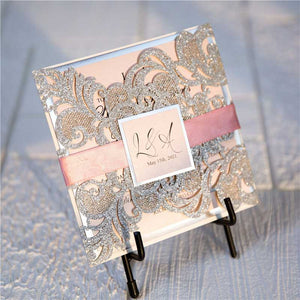 silver glitter laser cut invitation with pink ribbon closed