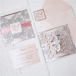 silver glitter laser cut invitation with pink ribbon