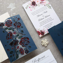 Floral rose laser-cut wedding invitation featuring roses on the panels, shown in navy