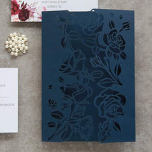 Floral rose laser-cut wedding invitation featuring roses on the panels, shown in navy