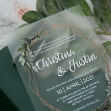 frosted weddingg invitation with greenery and geometric border closeup