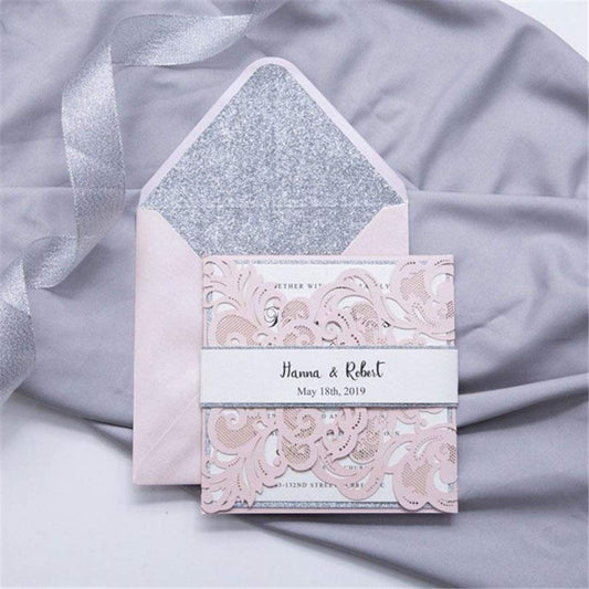 Laser-cut Gate Fold Wedding Invitation with swirl in blush pink with silver glitter backing card, belly band, envelope and liner