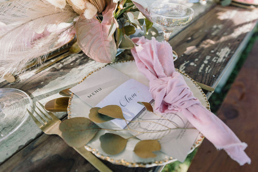 napkin wrap with pink napkin in a rustic wedding setting