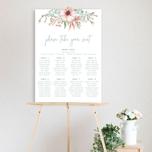 table seating chart featuring watercolour flower design and sitting on a timber easel