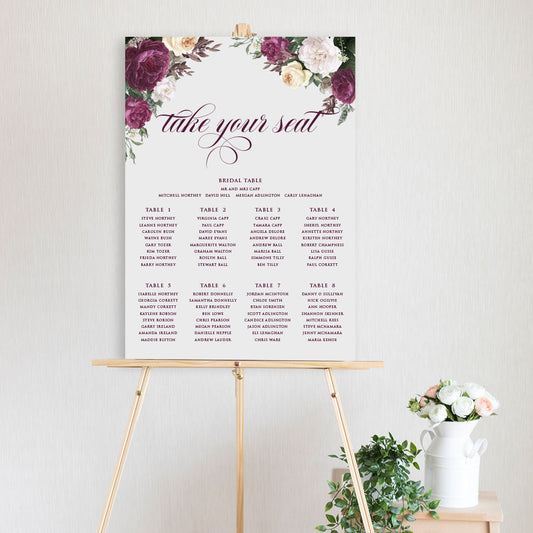 table seating chart featuring watercolour design with burgundy, white and yellow peonies and roses sitting on a timber easel