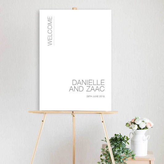 classic black and white welcome sign for wedding, engagement party of birthday sitting on timber easel