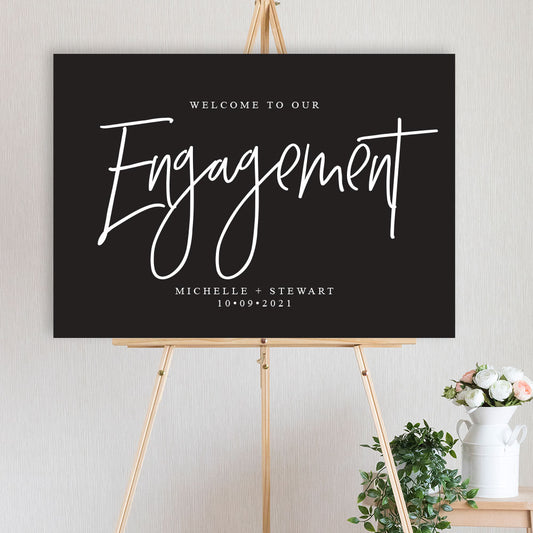 classic black and white engagement party welcome sign on timber easel