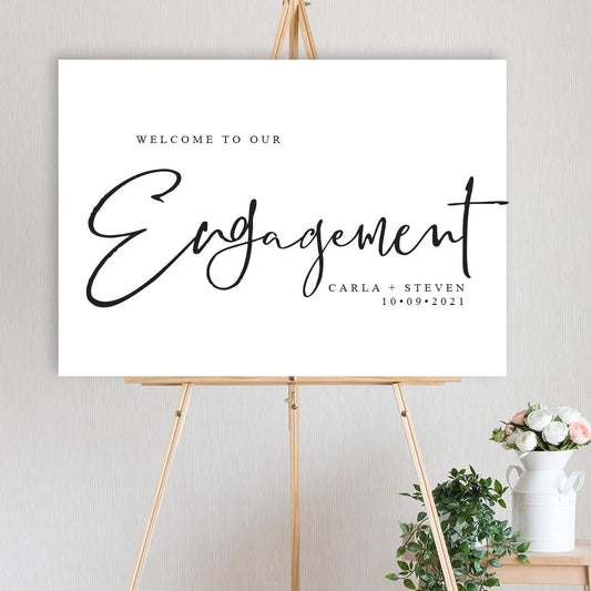 classic black and white engagement party welcome sign on timber easel