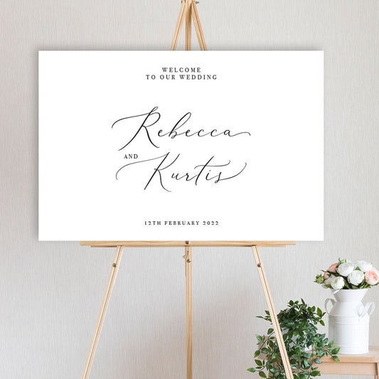 black and white modern script welcome sign on timber easel