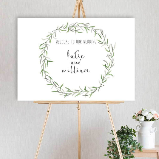 watercolour leaf wreath designed welcome sign for wedding, engagement or birthday party, sitting on a timber easel