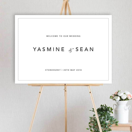 classic, modern black and white welcome sign for wedding, engagement or birthday party sitting on timber easel